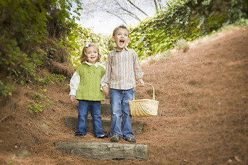 Image showing Two Children Walking Down Wood Steps with Basket Outside.