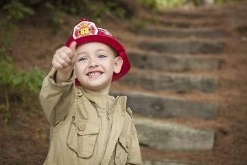 Image showing Adorable Child Boy with Fireman Hat Playing Outside