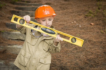 Image showing Adorable Child Boy with Level Playing Handyman Outside