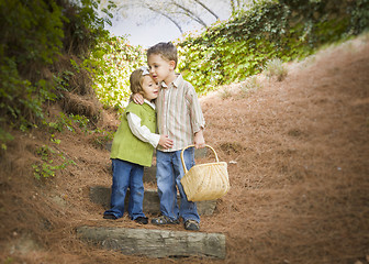 Image showing Two Children with Basket Hugging Outside on Steps