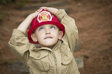 Image showing Adorable Child Boy with Fireman Hat Playing Outside