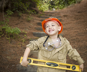 Image showing Adorable Child Boy with Level Playing Handyman Outside