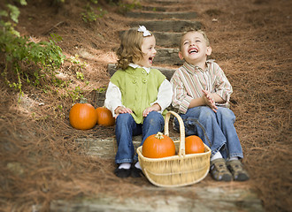 Image showing Brother and Sister Children Sitting on Wood Steps with Pumpkins