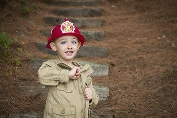 Image showing Adorable Child Boy with Fireman Hat Playing Outside