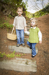 Image showing Two Children Walking Down Wood Steps with Basket Outside.