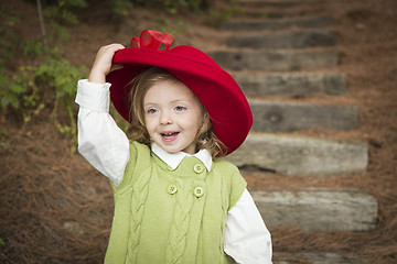 Image showing Adorable Child Girl with Red Hat Playing Outside