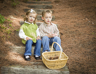 Image showing Two Children on Wood Steps with Basket of Pine Cones