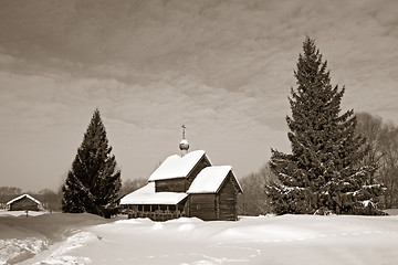 Image showing wooden chapel in winter village, sepia