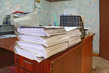 Image showing heap of the papers on table in office