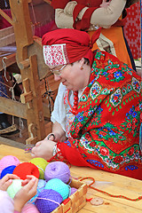 Image showing woman is in national cloth to sew