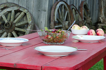 Image showing Salad glass dish and apples wooden homestead table 