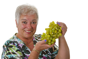 Image showing Female senior with grapes 