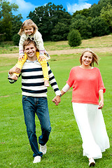 Image showing Portrait of family of three. Outdoor