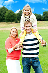 Image showing Pretty daughter enjoying day out with parents