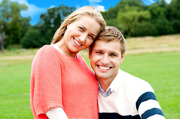Image showing Young couple outdoors sitting on green grass