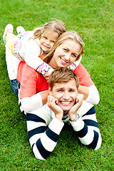 Image showing Husband, wife and child piled on each other