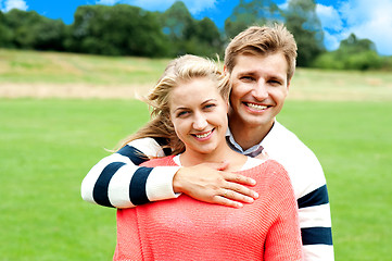 Image showing Husband hugging his wife from back