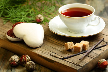 Image showing Spiced tea and ginger biscuits.