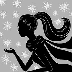 Image showing Silhouette of young woman with flying snowflakes