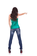 Image showing young casual woman points finger