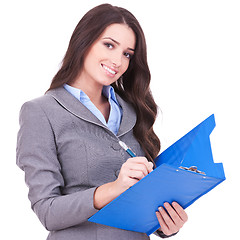 Image showing business woman writing on clipboard