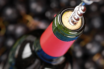 Image showing Opening a bottle of red wine