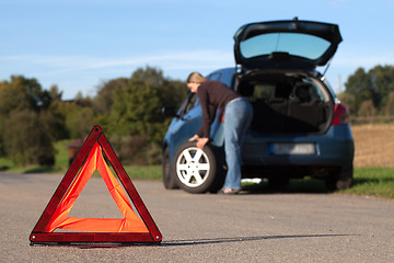 Image showing Broken down car with red warning triangle