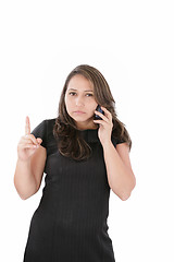 Image showing a woman with a serious expression on her face holding her phone 