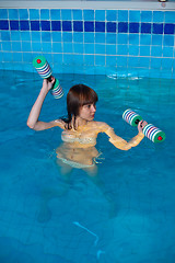 Image showing Pretty girl doing aqua aerobic exercise