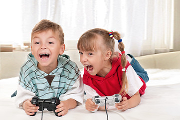 Image showing Happy girl and boy playing a video game