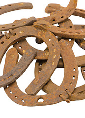 Image showing stack of old retro horse shoes isolated on white 