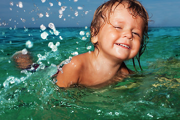 Image showing Happy kid splashing in the sea
