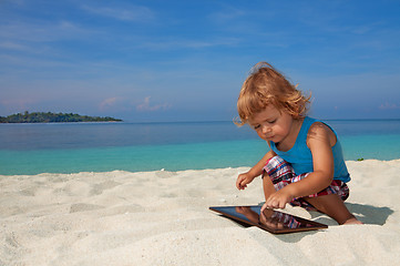 Image showing Happy boy playing on the beach