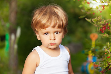 Image showing moody kid in the garden