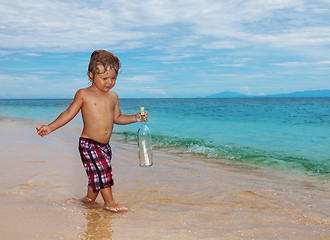 Image showing toddler holding sos bottle