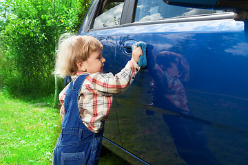 Image showing Cute kid washing parents car