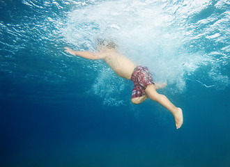 Image showing Little kid jumping in the water
