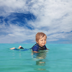 Image showing Little boy laying in the water