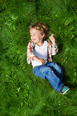 Image showing funniest kid rolling on grass