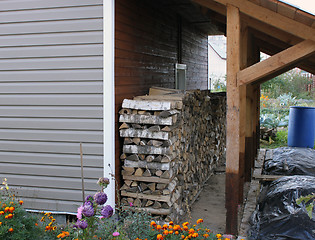 Image showing Fuel for a fireplace under a canopy