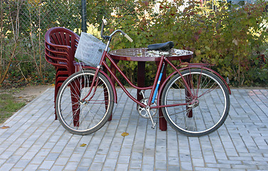 Image showing Plastic furniture and old bicycle