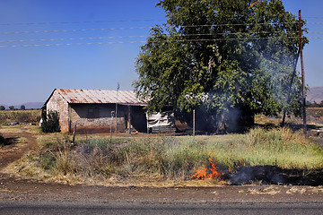 Image showing Felt Fire Close to Farm House