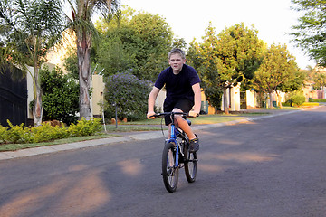 Image showing Young Boy Riding Bicycle