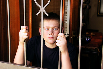 Image showing Young Boy Locked Inside House for Protection