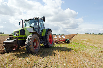 Image showing Closeup tractor plowing agricultural field autumn 