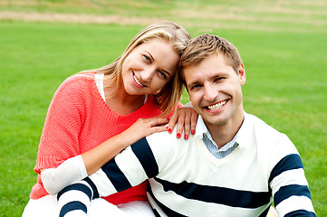 Image showing Adorable love couple, woman embracing her man