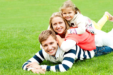 Image showing Husband, wife and child piled on each other