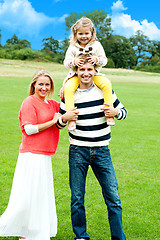 Image showing Cheerful family posing against nature background