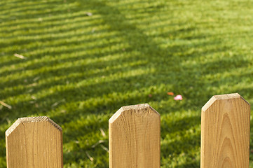 Image showing Wooden decorative fence and green garden