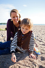 Image showing Mother and son at beach.